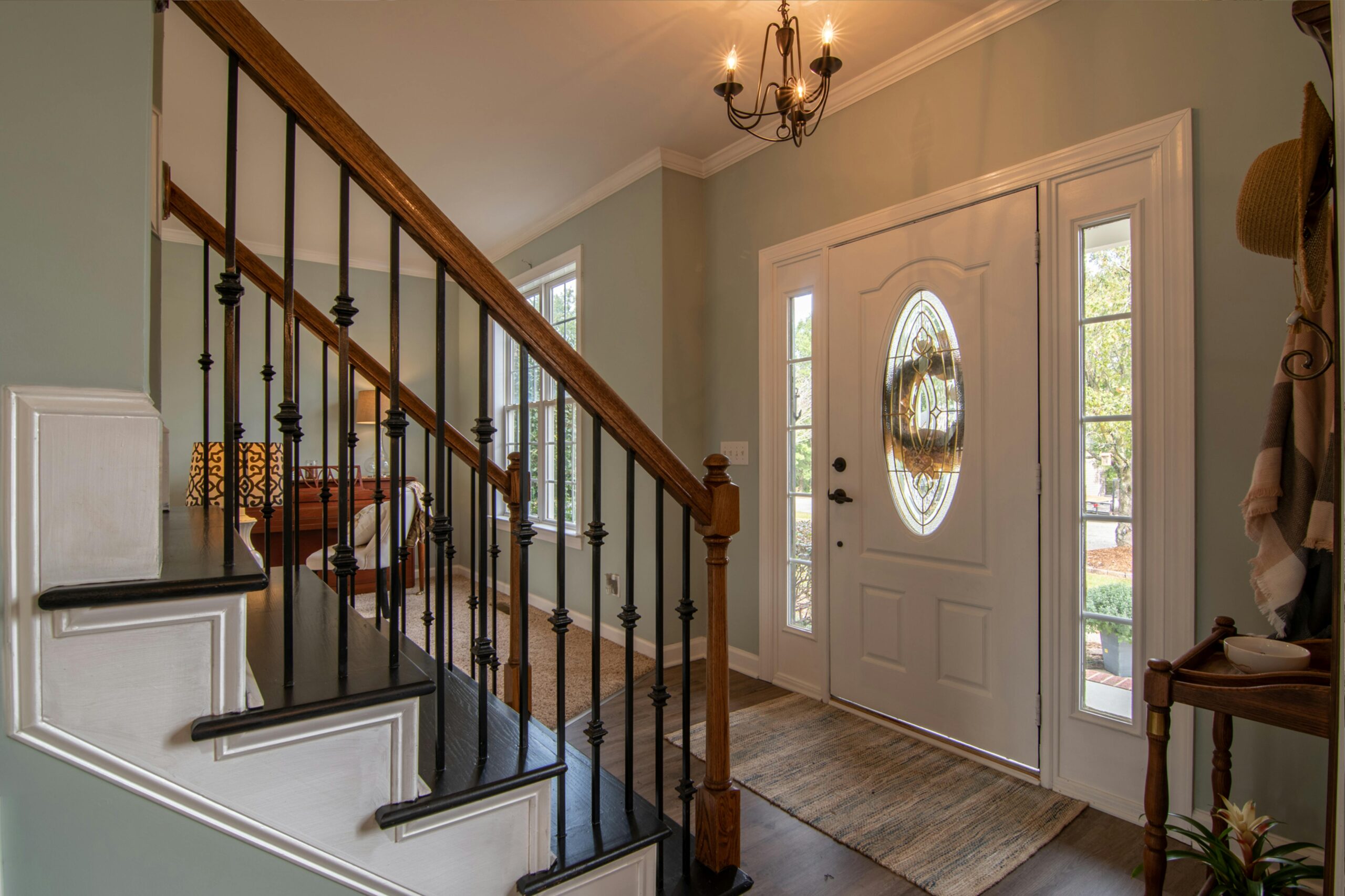 inside a house looking at a staircase and a front door